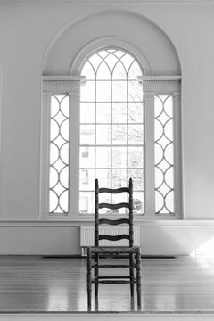 One Chair in Front of Ornate Window