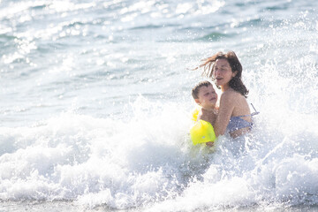 Fototapeta na wymiar Mother and son happy and having fun in the sea