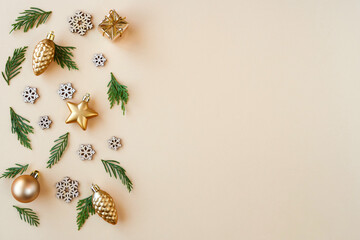 Christmas, New year composition. Gift box and holiday decorations on beige background . Flat lay. Top view with copy space	