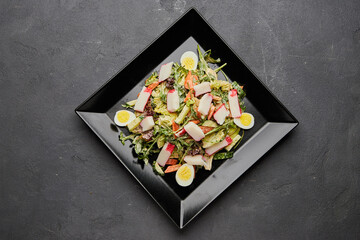 Crab stick salad with fresh vegetable and eggs.
