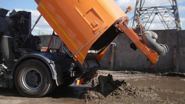 A truck is dumping concrete on a construction site