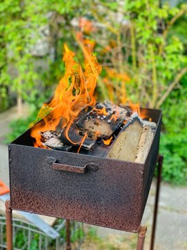 Family barbecue grill with fire In the garden summer time