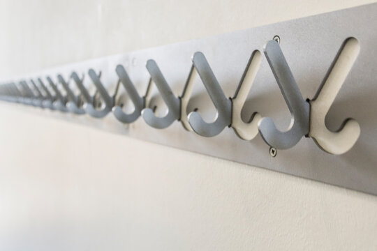 Row of empty hooks of a public cloakroom