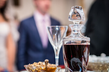 Red wine vessel with the glass, wedding church ceremony detail