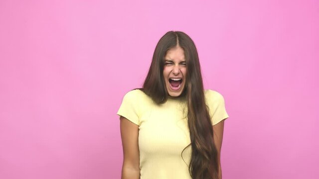 Young caucasian woman screaming very angry and aggressive