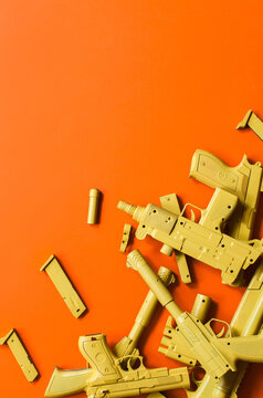 Different firearms on orange background.