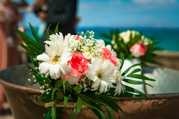 Flowers as decoration element metal baptismal font.	