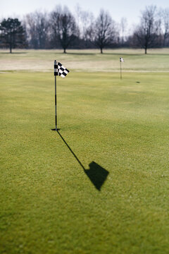 Putting green flag on golf course