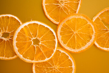 Dried orange slices. Healthy snacks. Top view. Golden background. Close up