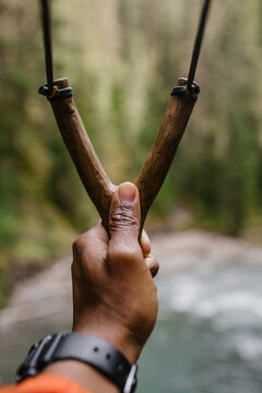 First person perspective of a man holding a sling shot