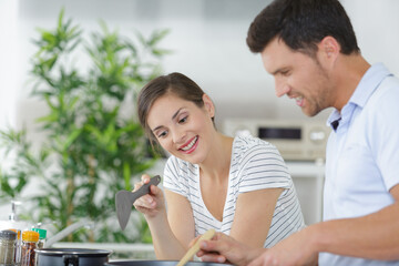 couple cooking food at home kitchen