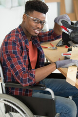 disabled worker in wheelchair in a carpenters workshop