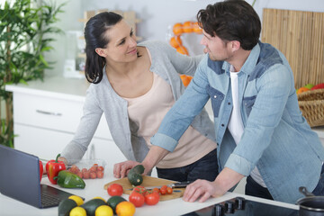 couple prepares a man in the kitchen