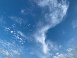 Blue sky with clouds. Scenic romantic cloudscape in heaven over Adriatic sea.  Beautiful white light clouds. Splendid divine heaven. Summer blue cloudy sky.