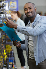 handsome man shopping tools at hardware store