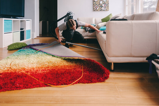 young man vacuuming