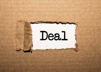The text DEAL behind torn brown paper