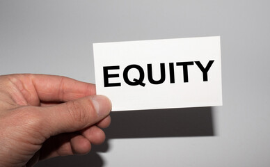 Message on the card EQUITY, in hands of businessman.