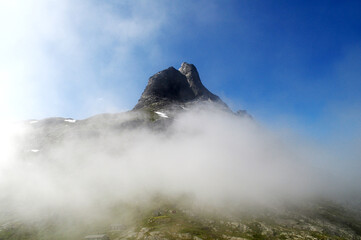 Fototapeta premium High rocky mountains shrouded in clouds, Troll road, Norway