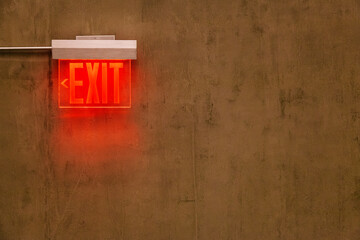 Exit Red Sign on a Brown Concrete Wall