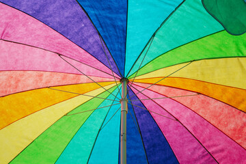 under a colorful beach umbrella