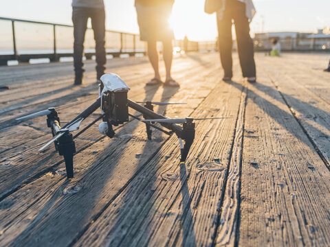 Man flying drone at sunset