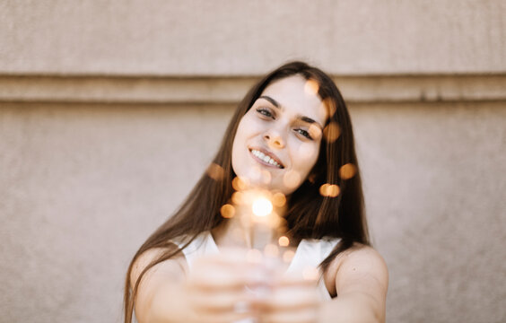 happy young woman with sparklers, selective focus