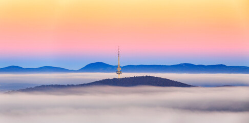 Canberra tower over the autumn fog - obrazy, fototapety, plakaty