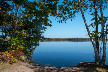 Welcoming lakeside beach surrounded by autumn colors