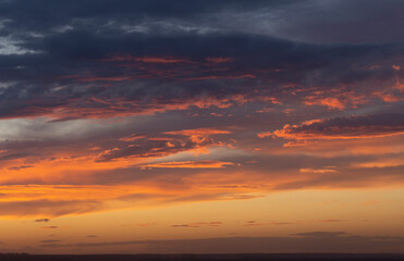 Purple-magenta clouds. Tragic gloomy sky. Landscape with bloody sunset. Fantastic skies on the planet earth. Twilight, nightfall.