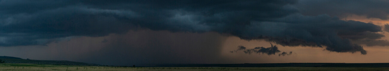 The eerie clouds had invaded the sky. Storm front over the fields. Downpour is approaching...