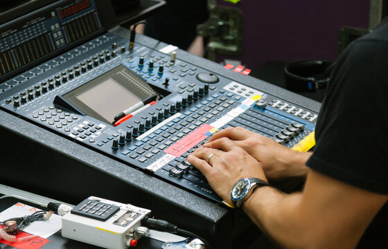 Sound Engineer Working with a Mixer in a Live Show