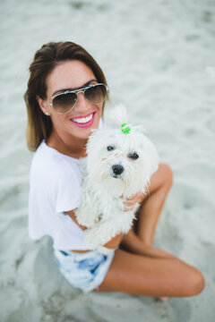 A woman and her dog on the beach