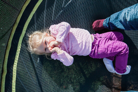 Cute litle girl having fun on trampoline