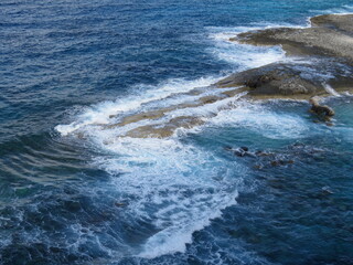Waves crashing on rocks of an island