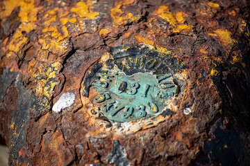 Macro photography of an old rusty mooring post on the waterfront in a small marina, element for mooring ships in the harbor, safety