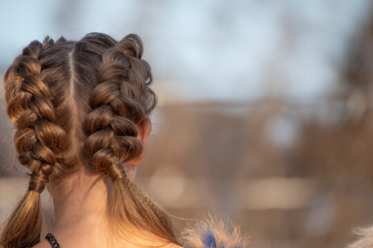 Hairstyle French braid inside out, on the head of a young girl.