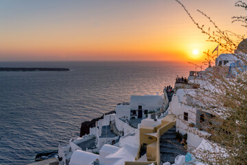 Beautiful panoramic view from Oia to caldera and volcano at sunset. Picturesque natural background with copy space for text. Santorini island, Cyclades, Greece, Europe.