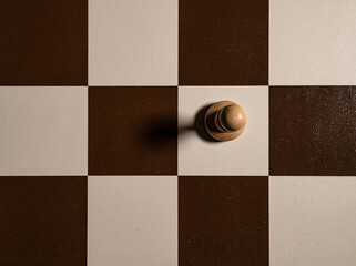 Chess pawn view from top one, board of cells, shadow falls to the side