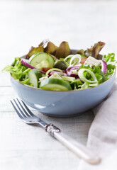 Salad with Green Olives, Cucumber and Feta Cheese. Bright wooden background.	