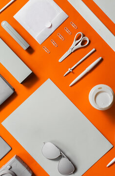 Well organised white and grey office objects on orange background