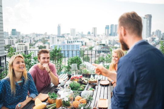 Group of Friends Eating Together on a Balcony