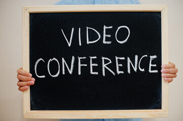 Video conference. Coronavirus concept. Boy hold inscription on the board.