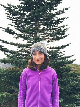 Portrait of happy twelve year old girl outdoors