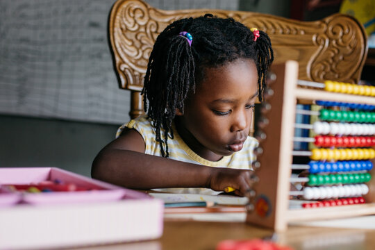 Black girl working on her kindergarten homework