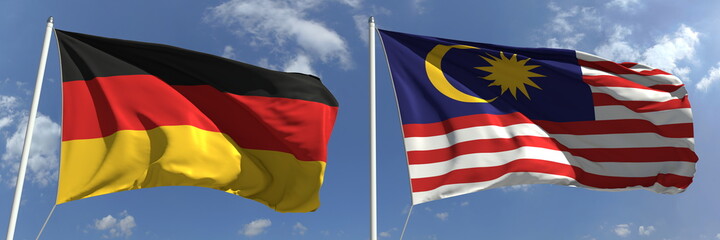 Flying flags of Germany and Malaysia on high flagpoles. 3d rendering