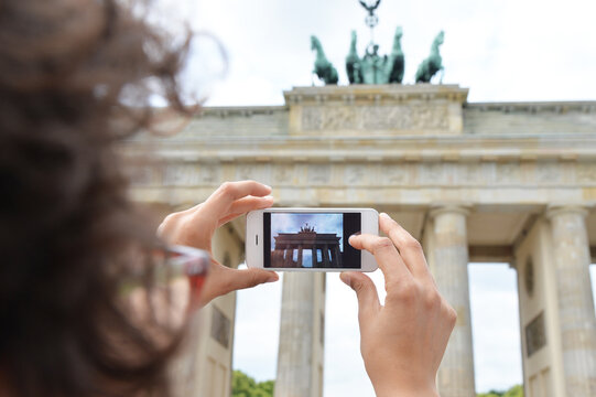 Woman taking pictures in Brandenburg Gate