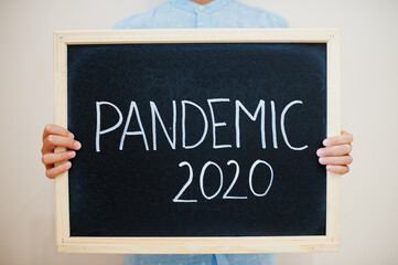 Pandemic 2020. Coronavirus concept. Boy hold inscription on the board.