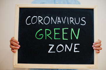 Green zone. Coronavirus concept. Boy hold inscription on the board.