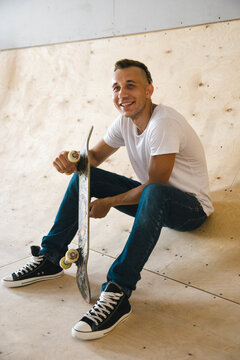 Cheerful skater in the half-pipe